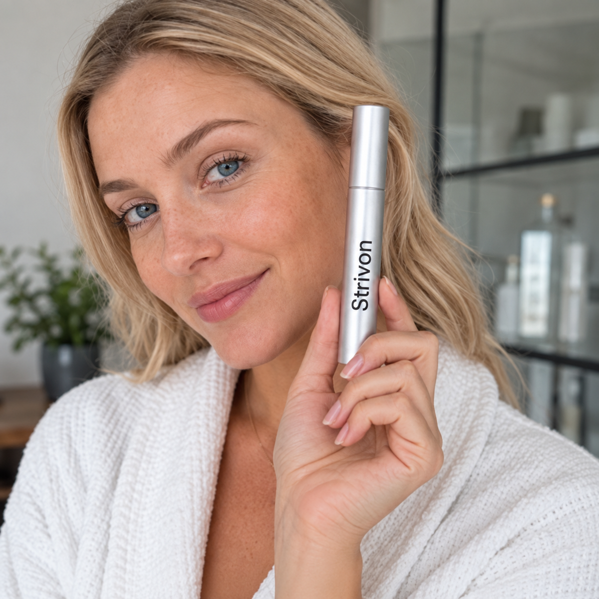 Woman holding Strivon Eyelash Growth Serum
